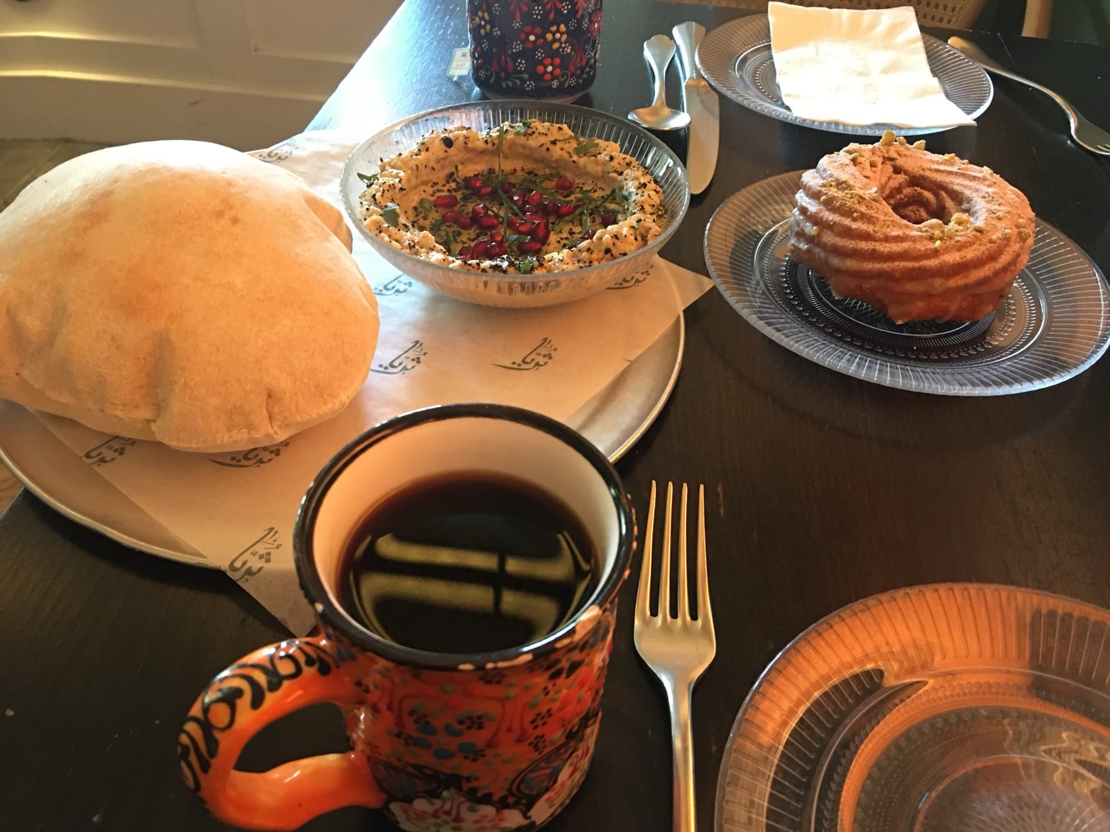 Breakfast in Fishtown: fresh pita, a spread, a pastry and a mug of coffee
