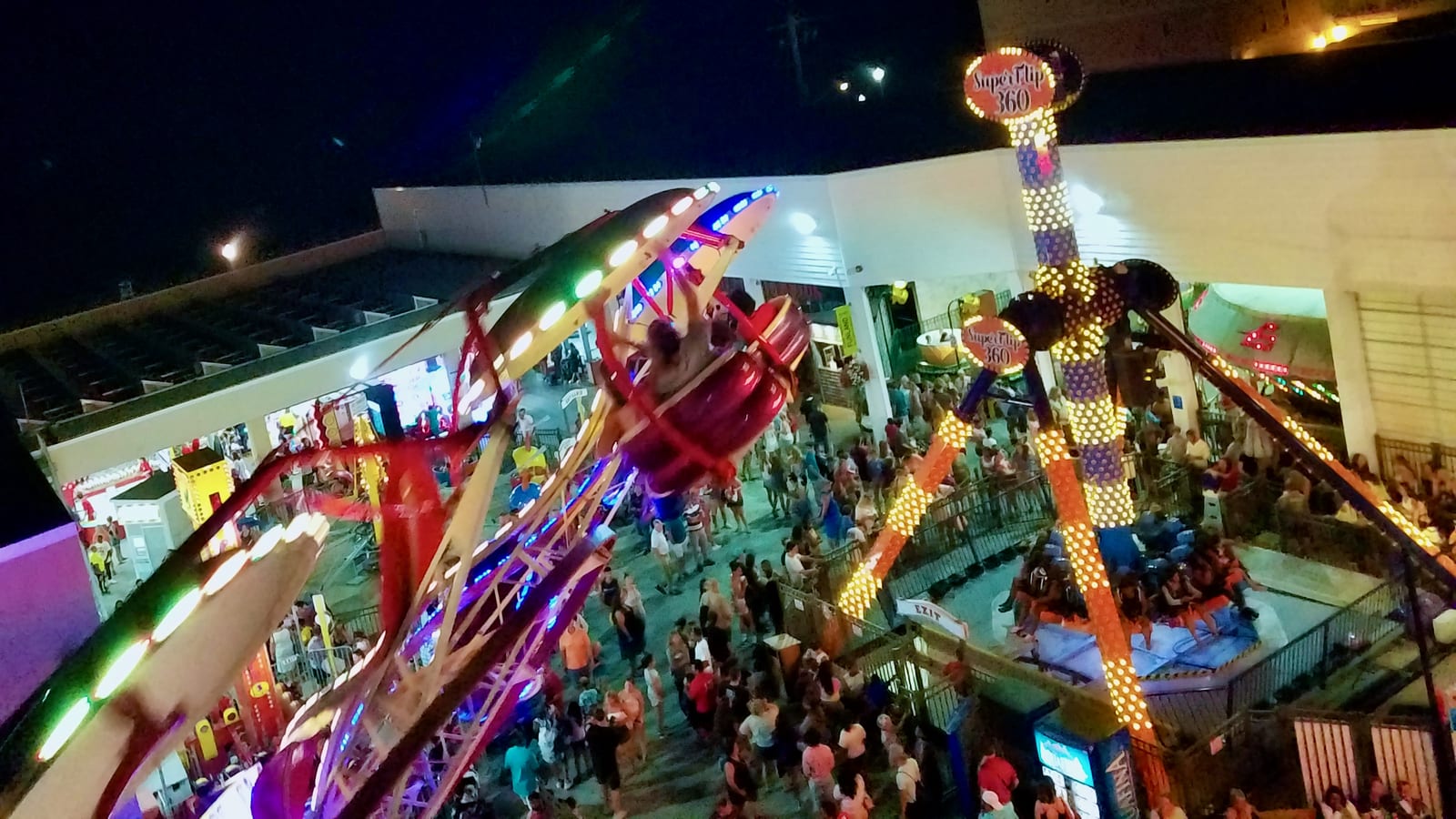 Funland rides lit up at night on the Rehoboth Beach boardwalk