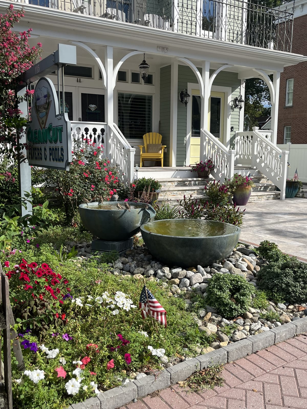 A white-porched house with a flower garden in historic Lewes