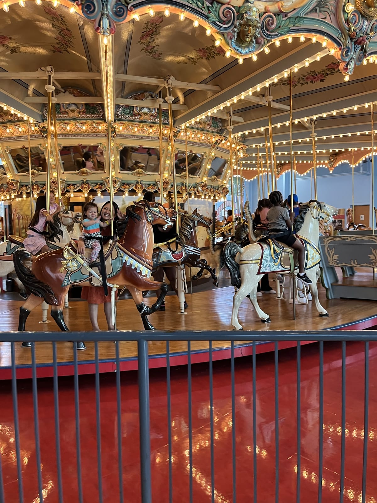 The historic wooden carousel inside the Please Touch Museum