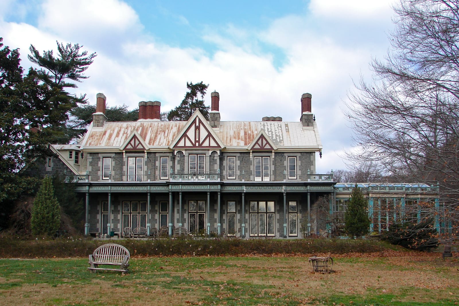 The Gothic-Revival stone mansion at Rockwood Park & Museum in Wilmington, Delaware, with its long covered veranda and gabled roofline.