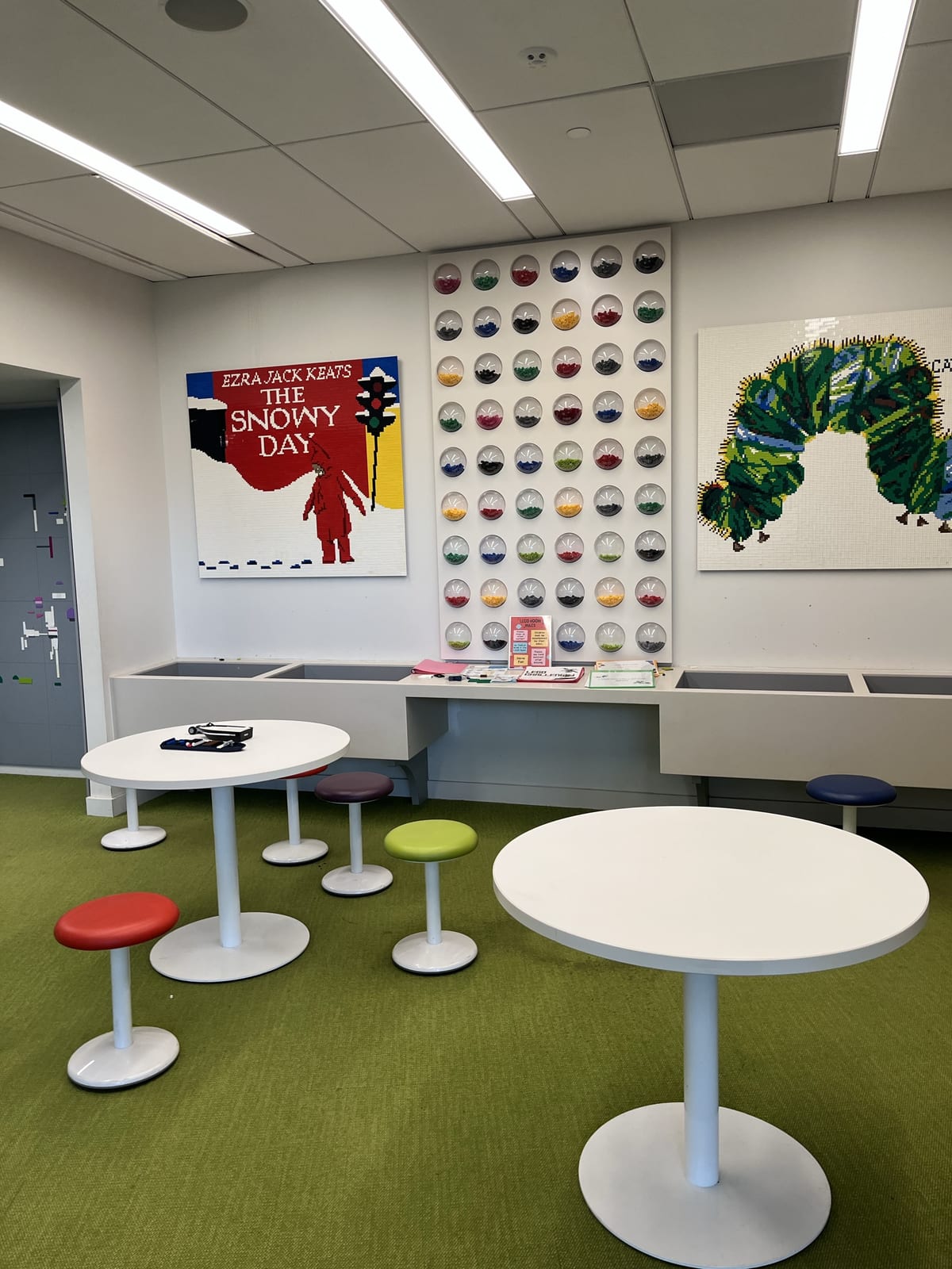The children's area at Route 9 Library, with colorful stools and picture-book art on the walls